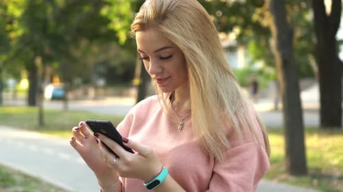 Girl Is Using Smartphone on Street