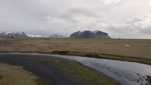 Aerial view of beautiful Iceland countryside with snowy mountain reflecting i
