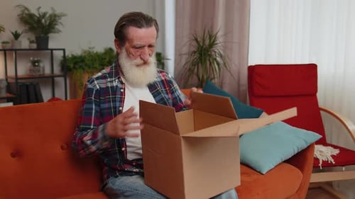 Angry Dissatisfied Shopper Senior Old Man Unpacking Parcel Feeling Upset Confused Wrong Delivery