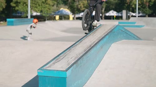 BMX Biker Performs Trick on Ramp