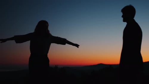 Couple Embracing at Colorful Sunrise Silhouette