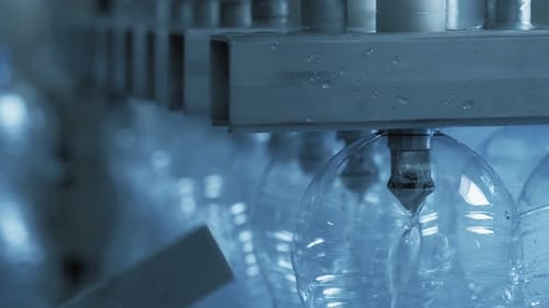 Automatic Conveyor Line for Bottling Mineral Water and Covering Caps on Plant. Industrial Production