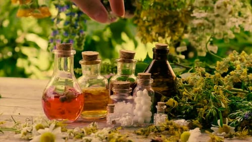 Bottles with Herbal Medicine on Nature Background