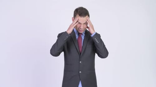 Studio Shot of Stressed Businessman Having Headache