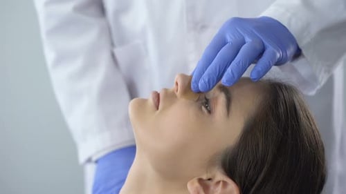 Woman Receives Medical Check Up on Nose