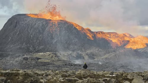 Man Watching Lava Erupting From Fagradalsfjall Volcano In Iceland