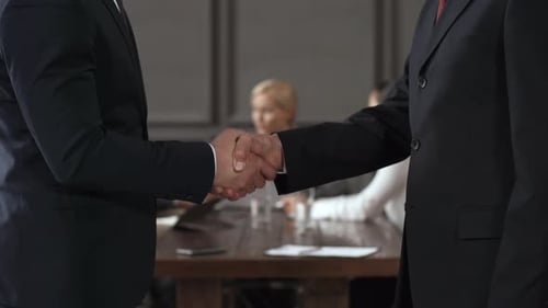 Business Handshake Meeting in Modern Boardroom
