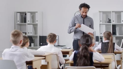 Teacher Lecturing to Elementary Students in Classroom