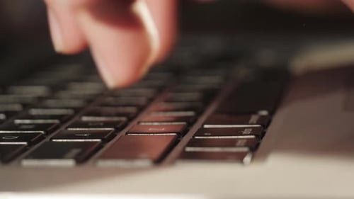 Fingers Typing on Laptop Keyboard Close Up