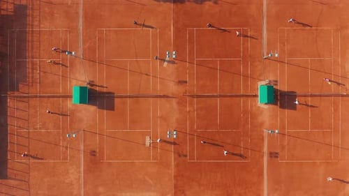 Aerial View of Multiple Tennis Courts with Players