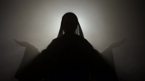 Mysterious Silhouette Raising Arms in the Air