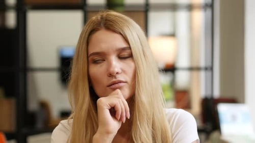 Woman Thinking Indoors with Hand on Chin