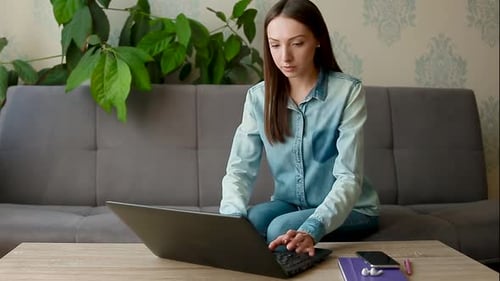 Woman Working on Laptop from Home on Couch