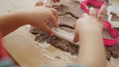 Child Baking Cookies With Cookie Cutters at Home