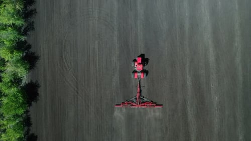 Tractor Processes the Field, Plowing the Field. View From a Copter, Modern Agricultural Machinery