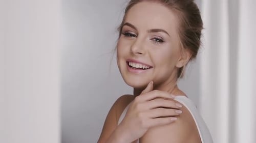 Smiling Woman Posing Gracefully in a Beauty Portrait