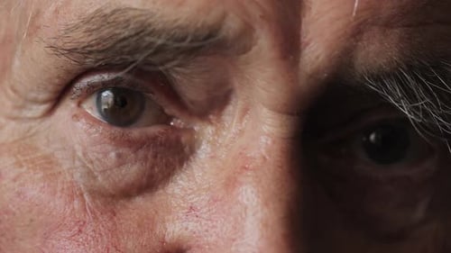 Senior Adult's Eyes Blink in Extreme Close Up
