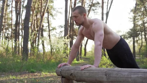 Man Doing Push Ups in Forest