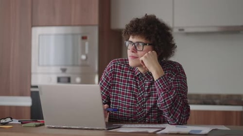 Young Adult Working on Laptop at Home