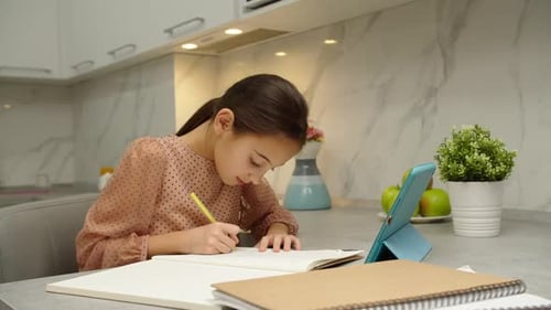 Schoolgirl Writing in Copybook Raising Hand to Answer to Tutor Online