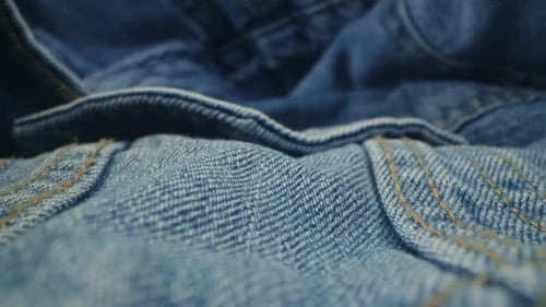 Macro Shot of Blue Denim Jeans Material. Slider Dolly Extreme Close-up of Clothing Material Fabric
