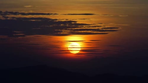 Glowing Sunrise Over Mountainous Landscape
