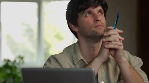 Thoughtful Man Contemplating Ideas Near Laptop