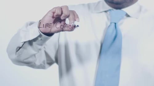 Man Writes Life Coaching on Glass Surface