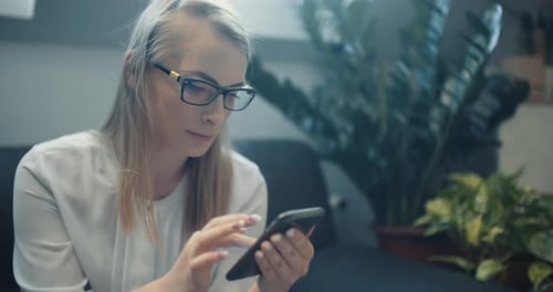 Young Woman Using Smartphone Indoors