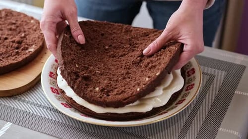 Hands Assembling Delicious Layer Chocolate Cake