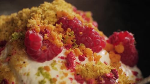 Delicious Dessert with Raspberries and Crumbs Close Up