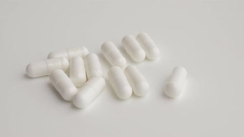 Pills Falling Out Of Bottle