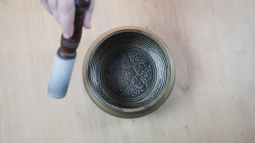 Striking Tibetan Singing Bowl with Wooden Mallet