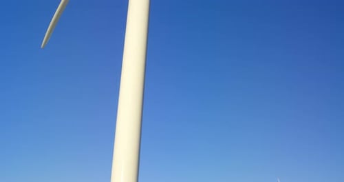 Wind turbine in the field on a sunny day 4k
