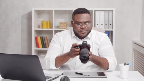 Workplace of freelance worker at home office. Young African-American man.