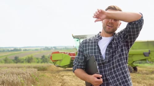 Tired Farmer Working at Grain Farm