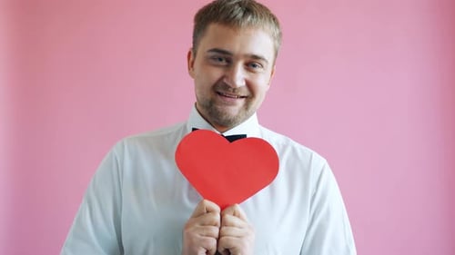 Man Holding Red Heart Shape in Studio