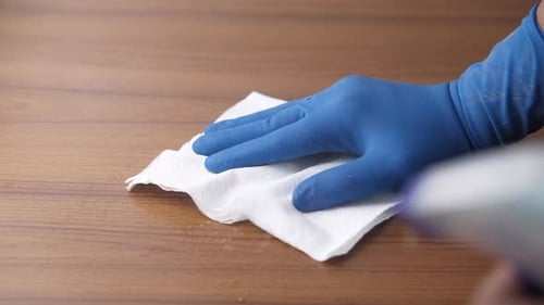 Gloved Hand Wipes Down Surface for Cleanliness
