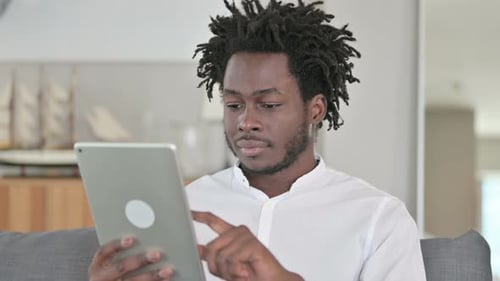 Young Adult Using a Tablet Indoors