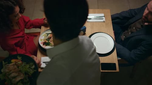 Waiter Serving Italian Dinner to Couple in Restaurant