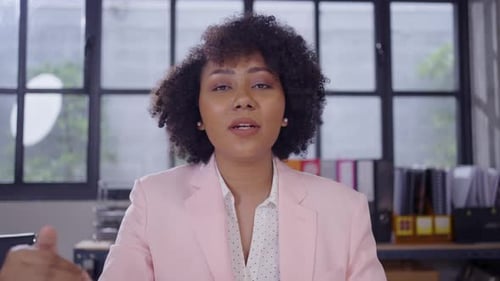 Woman Speaking to Camera in Office Setting