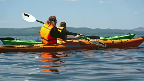 Kayakers Paddling on Lake in the Sunshine