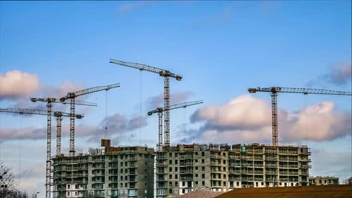 Construction Timelapse. Cranes Working On Residential Building Construction. Clouds And Blue Sky.