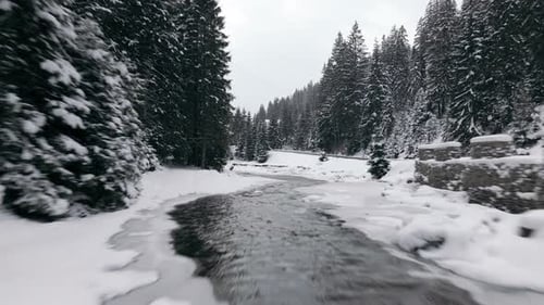 Aerial View Drone Moving Above the Frozen River in Mountains