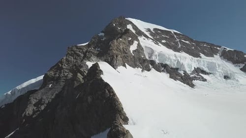 Orbiting Shot of Swiss Mountain and Its Peak Covered in Snow