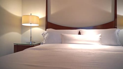 Clean Hotel Bed with Lamps and White Linens