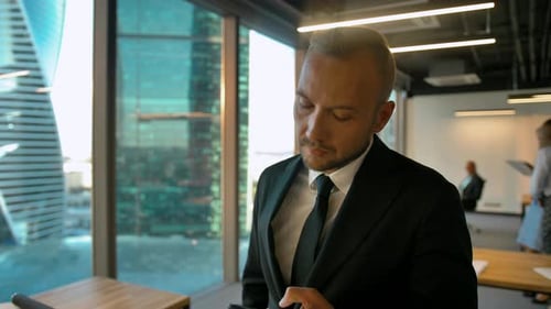 Confident Businessman in Office Openspace Calling To His Deal Partner