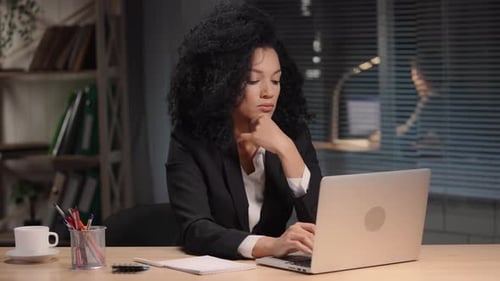 Woman Working on Laptop in Modern Office