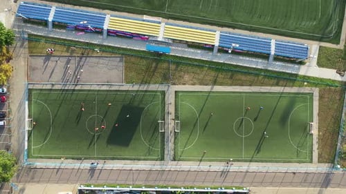 Top View of a Sports Football Field with Players Playing Football