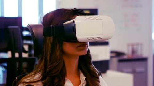 Woman uses Virtual Reality Headset in Office